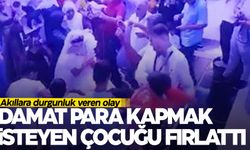 Düğünde gergin anlar… Damat para kapmak isteyen çocuğu fırlattı!