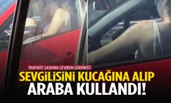 Sevgilisini kucağına alıp araba kullandı