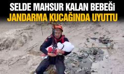 Selde mahsur kalan bebeği jandarma kucağında uyuttu