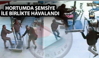 Hortumda şemsiye ile birlikte havalandı