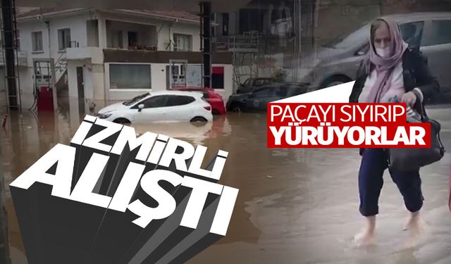 İzmir'i yine sağanak vurdu: Kimileri duraklara sığındı, kimisi paçaları sıvayıp yürüdü